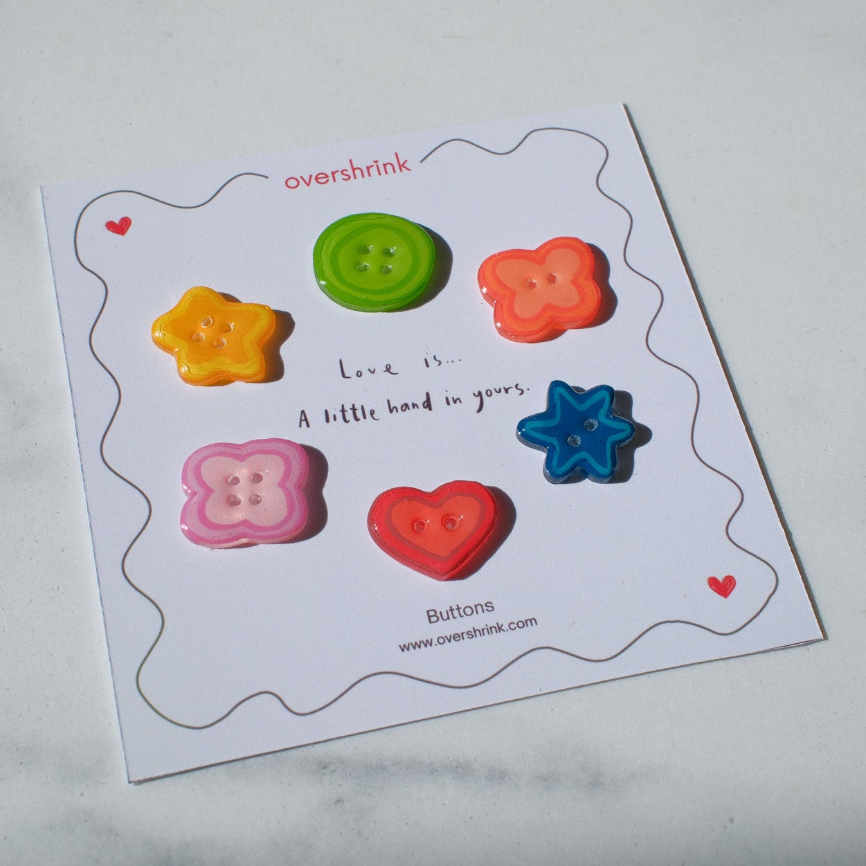 Colorful buttons on a card with text on a marble surface