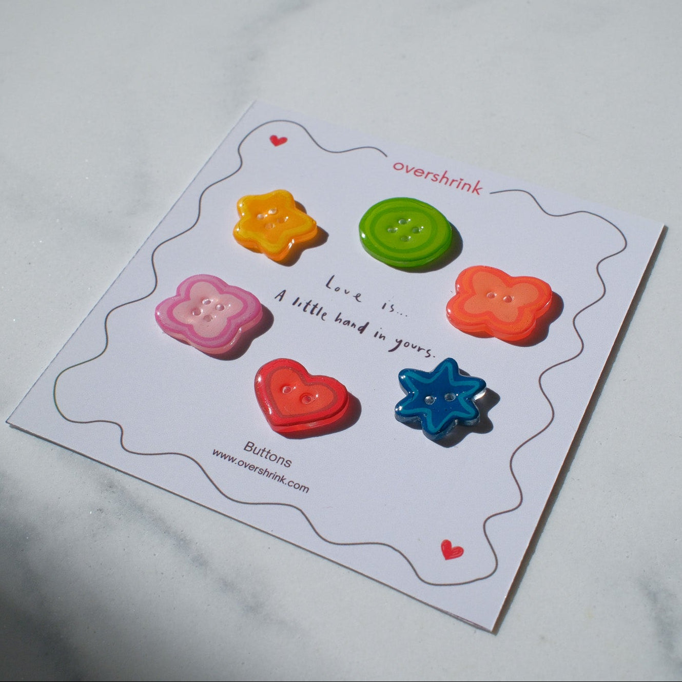Colorful buttons on a card with text on a white surface