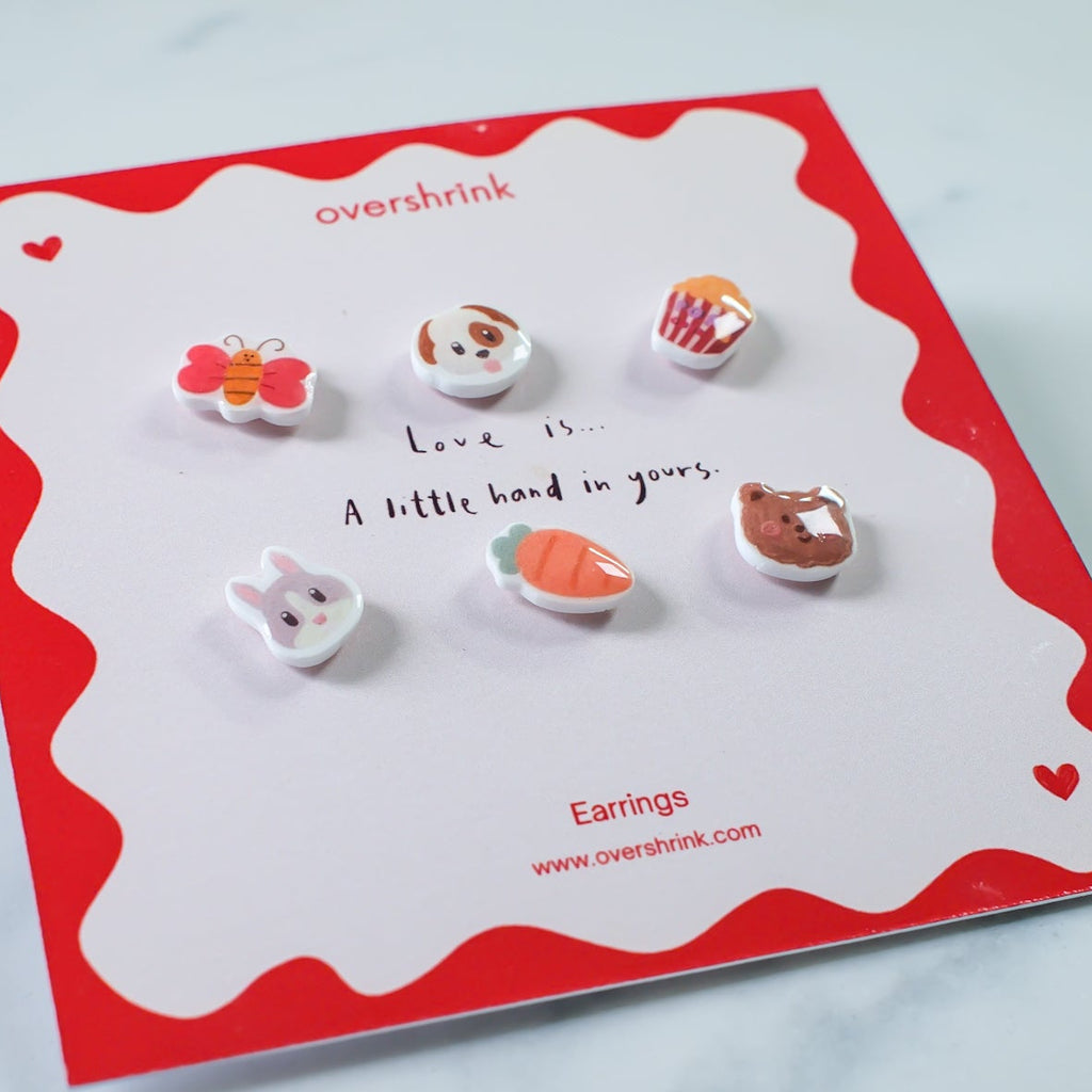 Set of earrings on a branded card with a red border